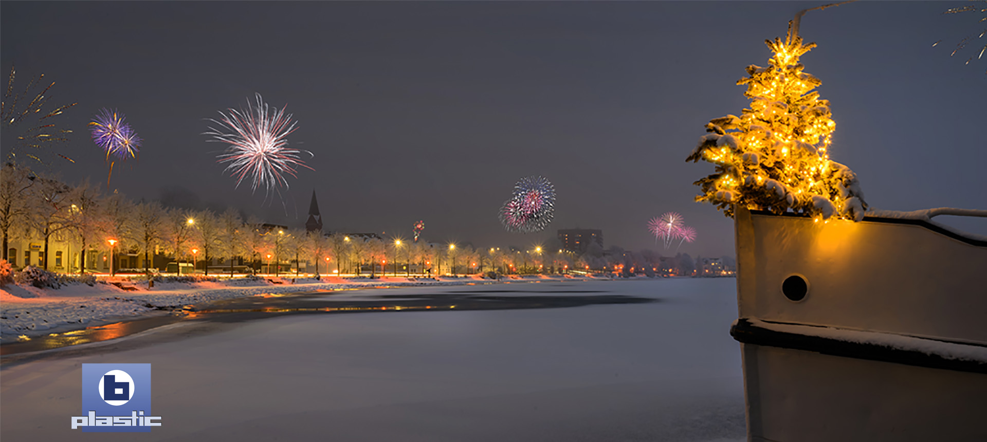 Ship at the harbour with decorated Christmas tree and illuminated promenade